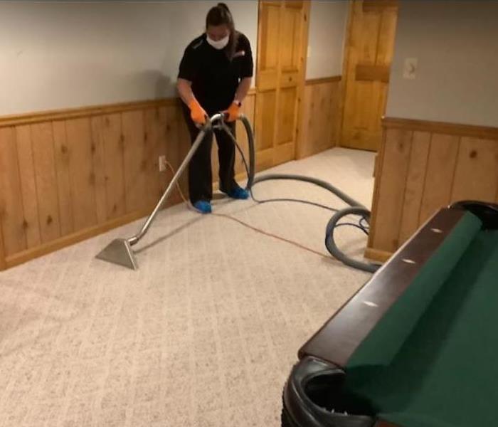 crew member extracting water from carpet in residential home