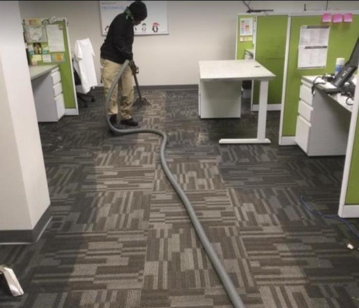 technician extracting water from carpet
